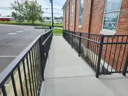 Metal ramp railing project for accessible commercial entry.