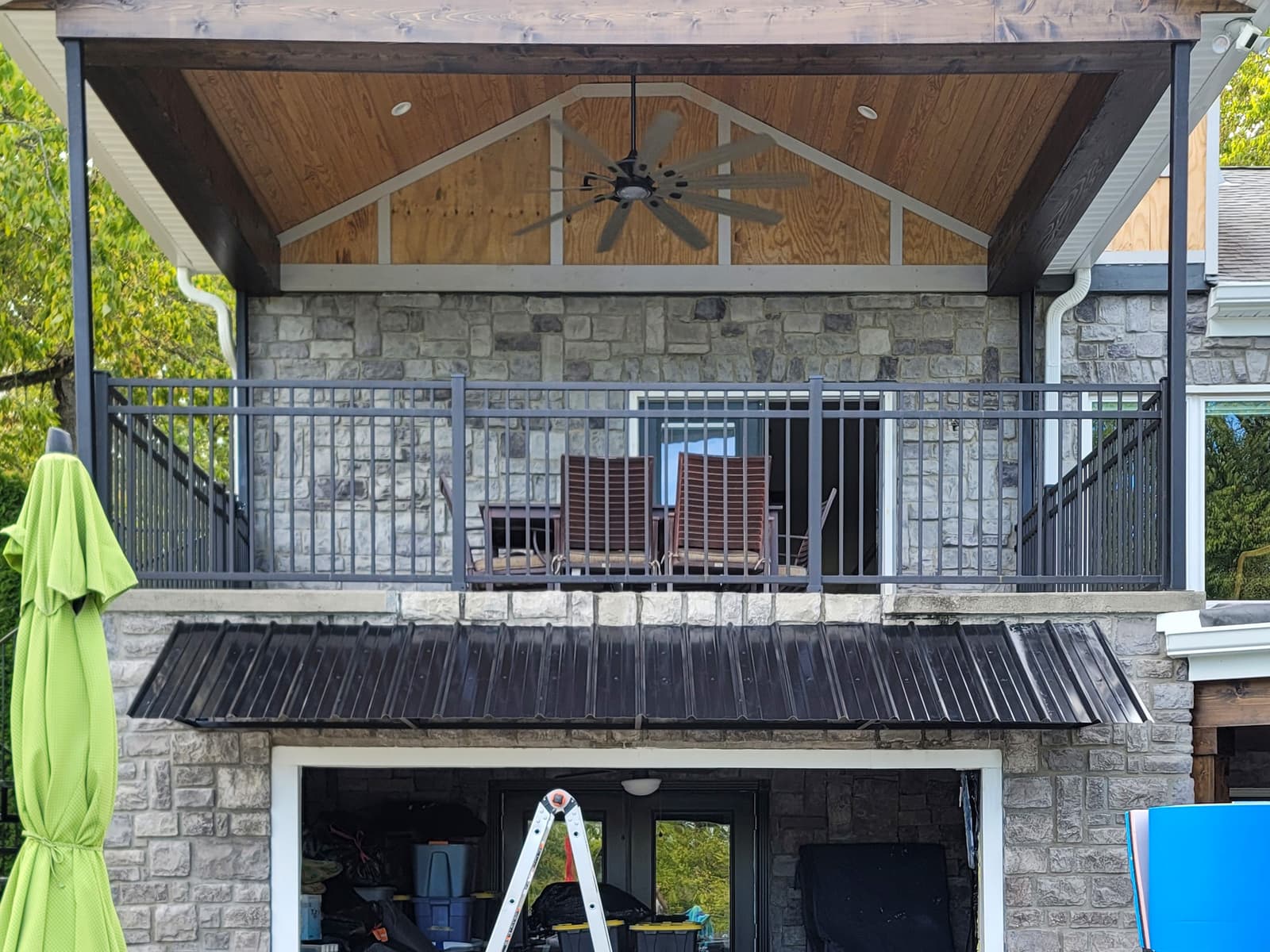 Metal awning support frame fabricated around an entry opening.