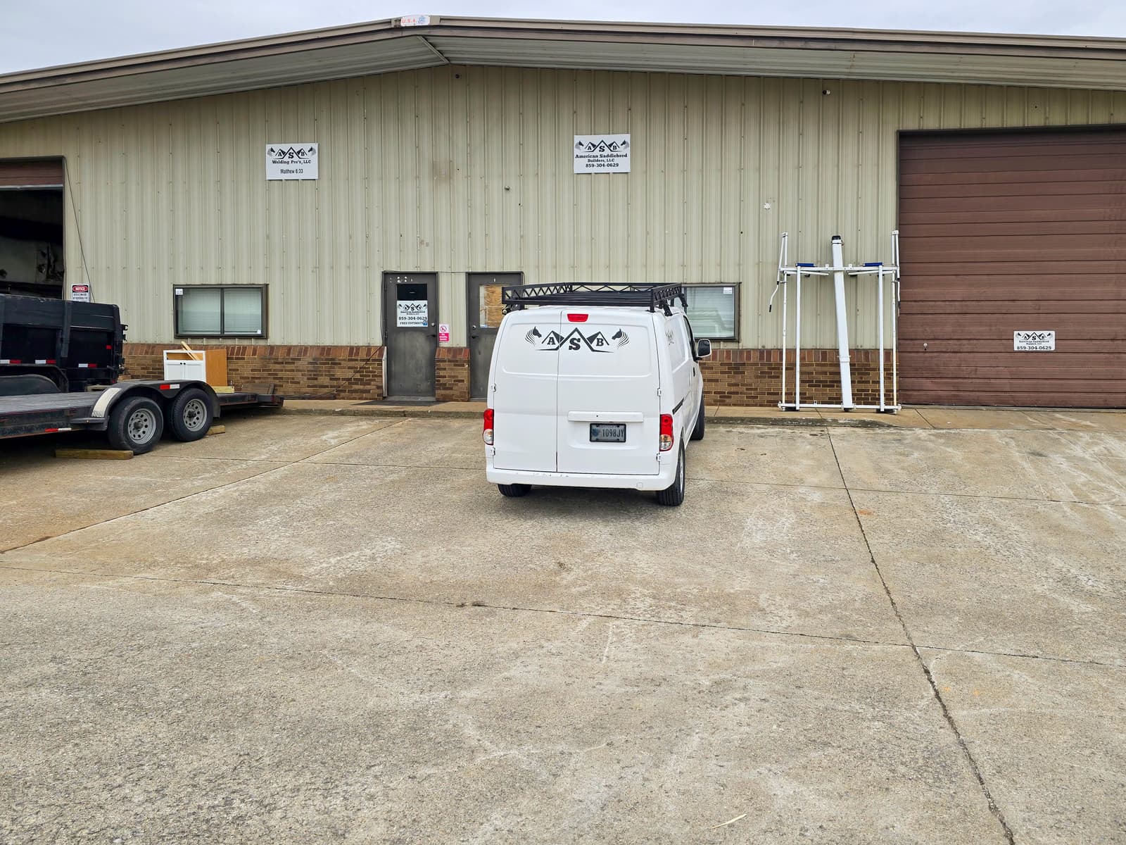 Welded crossmembers and perimeter frame on a custom work-vehicle rack.