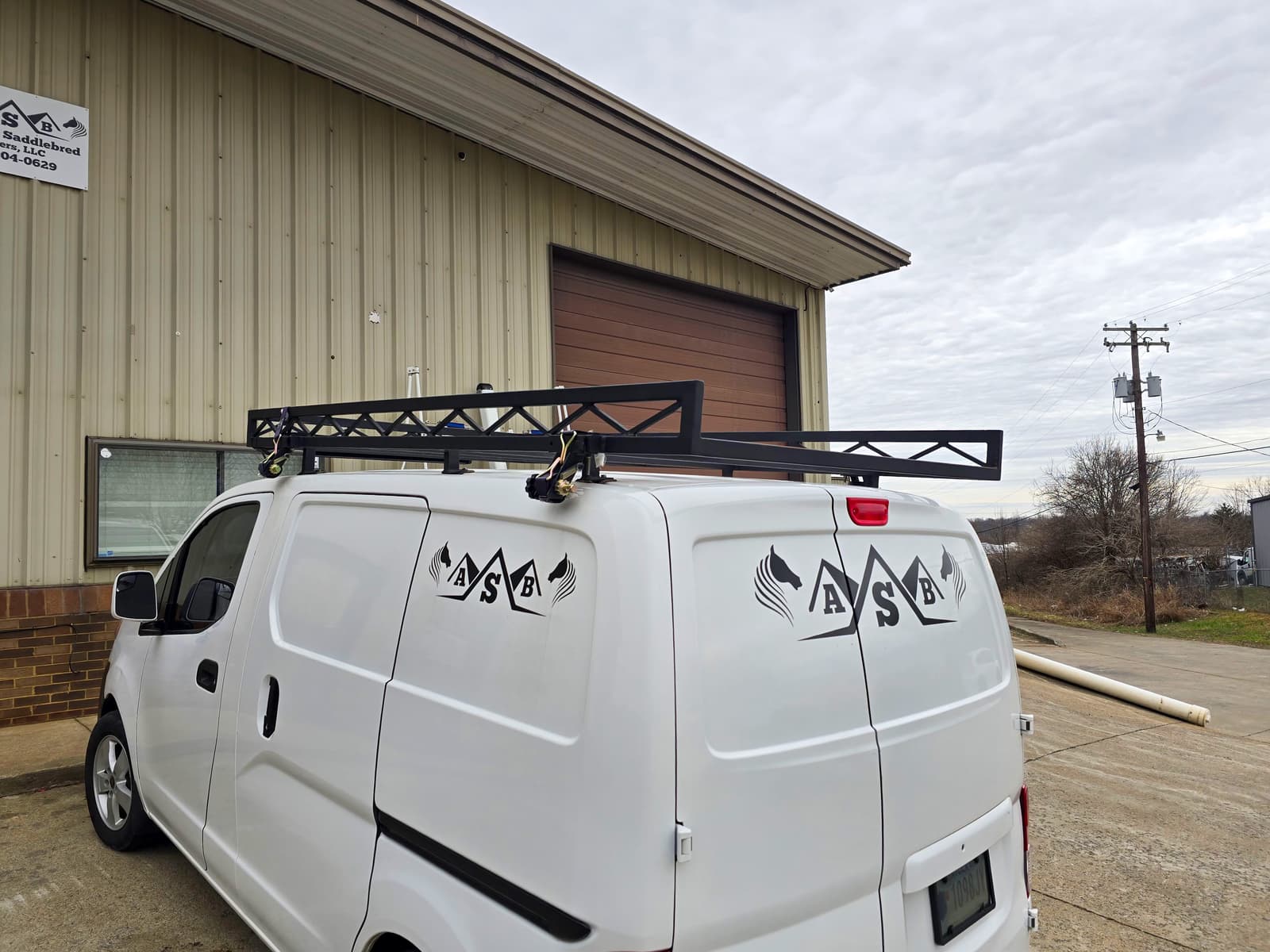 Custom metal roof rack fabrication for a work vehicle.