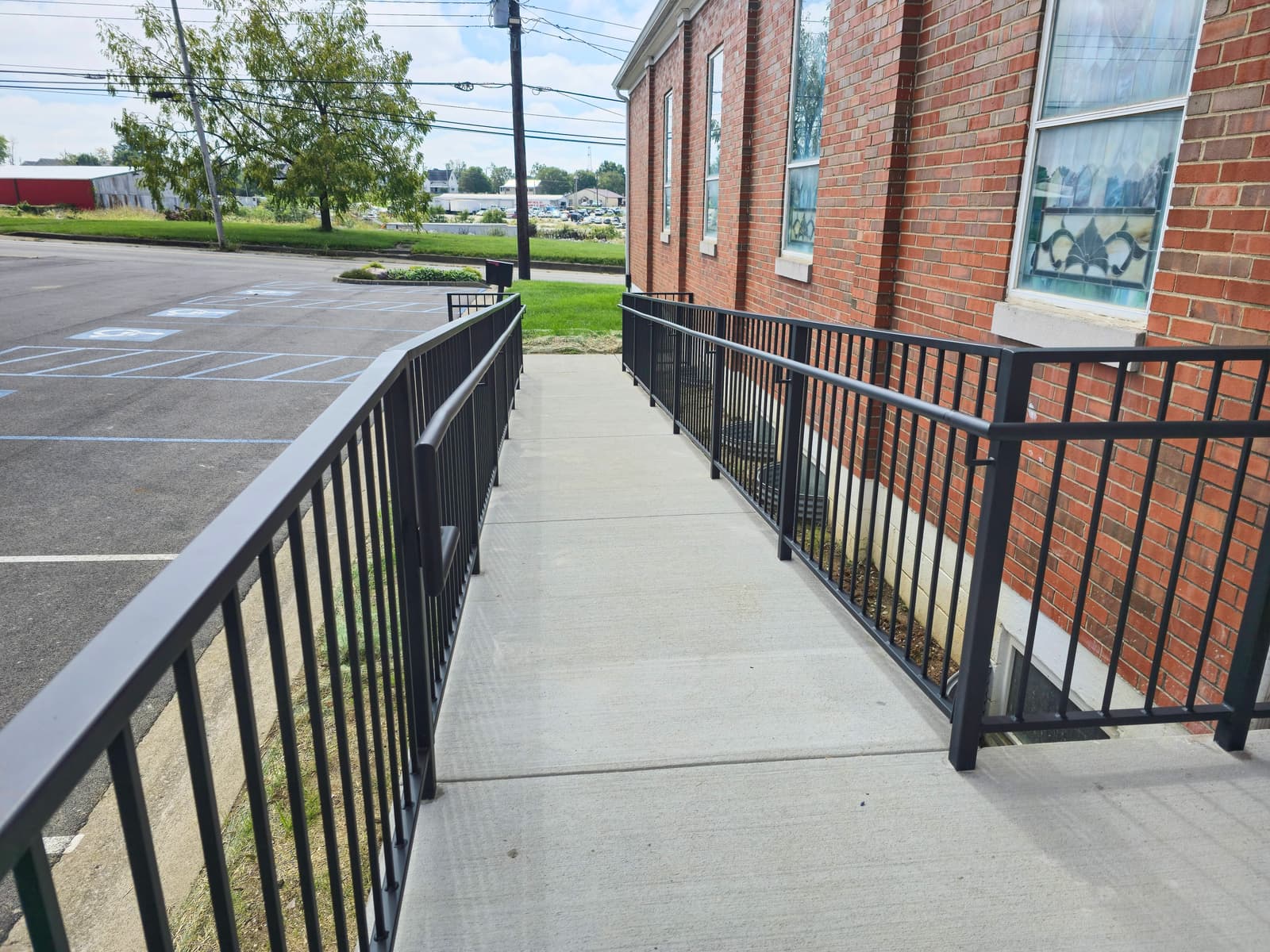 Metal ramp railing project for accessible commercial entry.