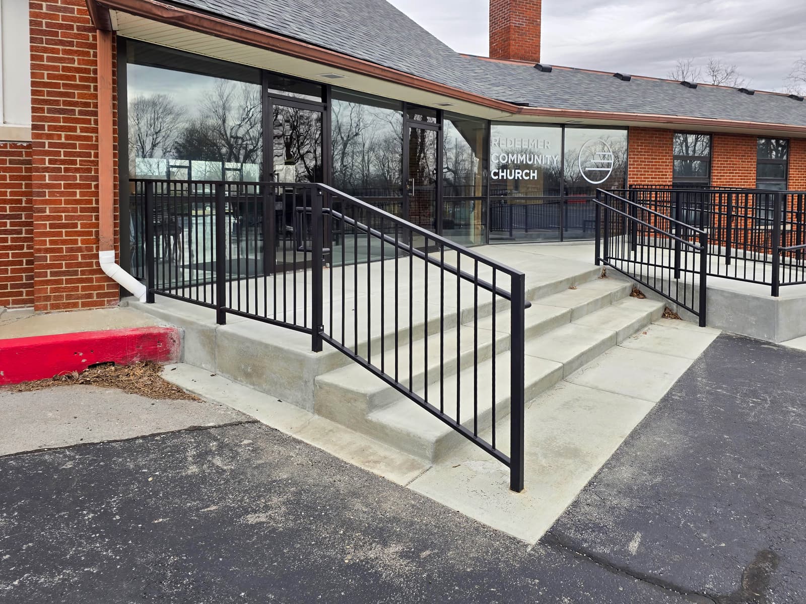 Black metal handrails and guardrails at a church entrance.