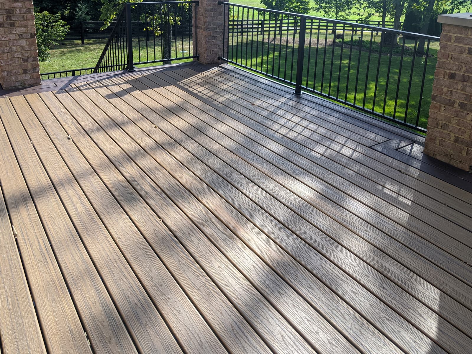 Black metal deck railing with welded posts and finished details.