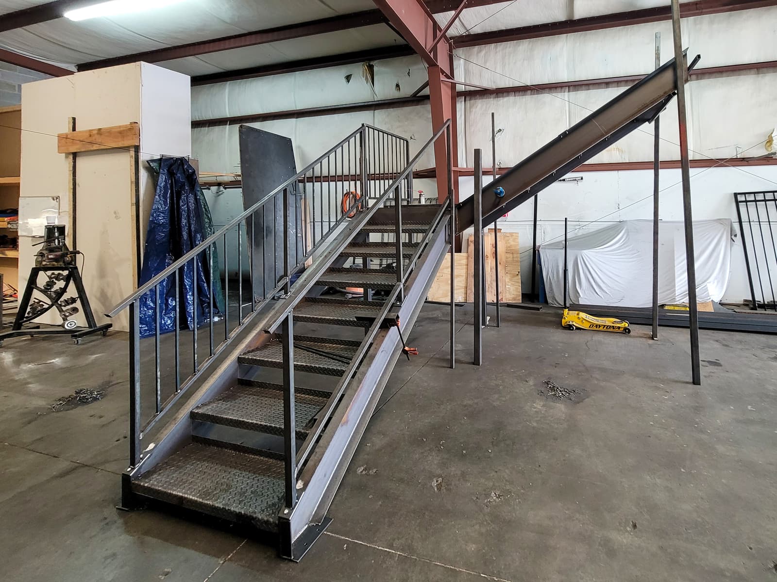 Freestanding steel staircase with treads and railings assembled in the shop.