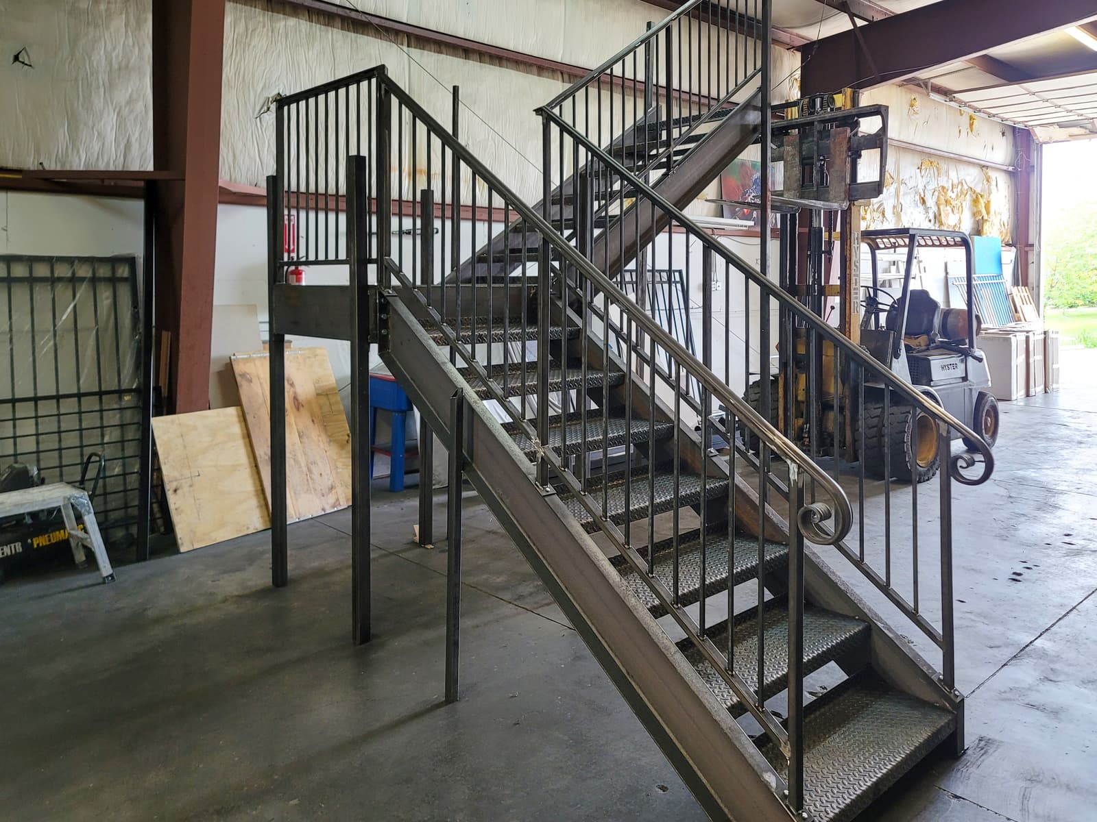 Deck metal staircase construction with welded stringer details.