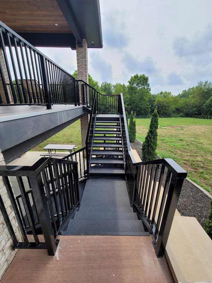 Black metal deck staircase with welded railing and stair stringers.