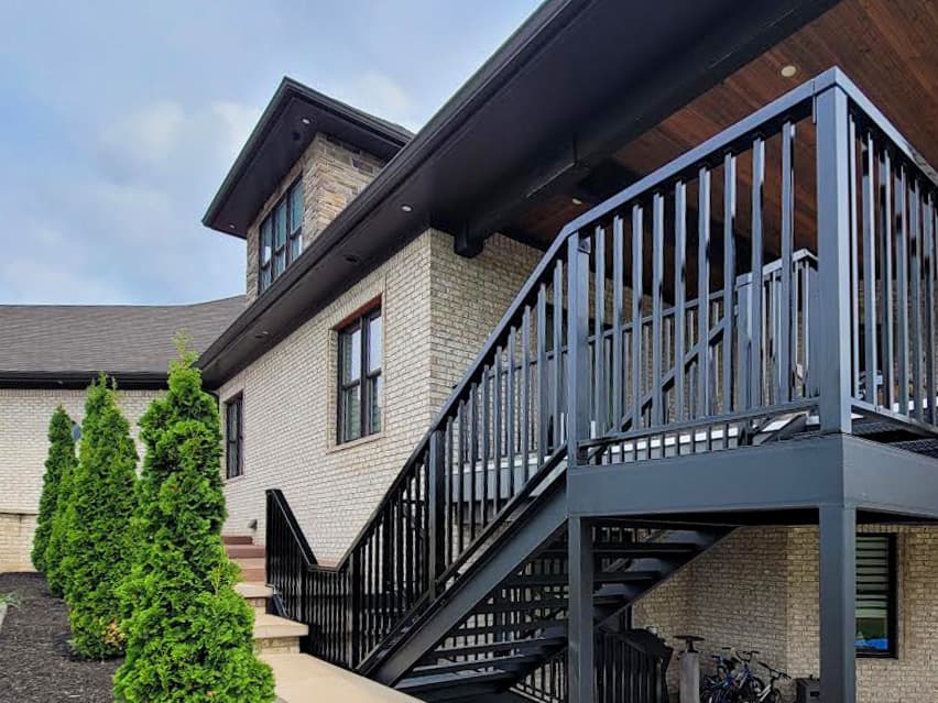 Black metal deck staircase installation viewed from the landing.