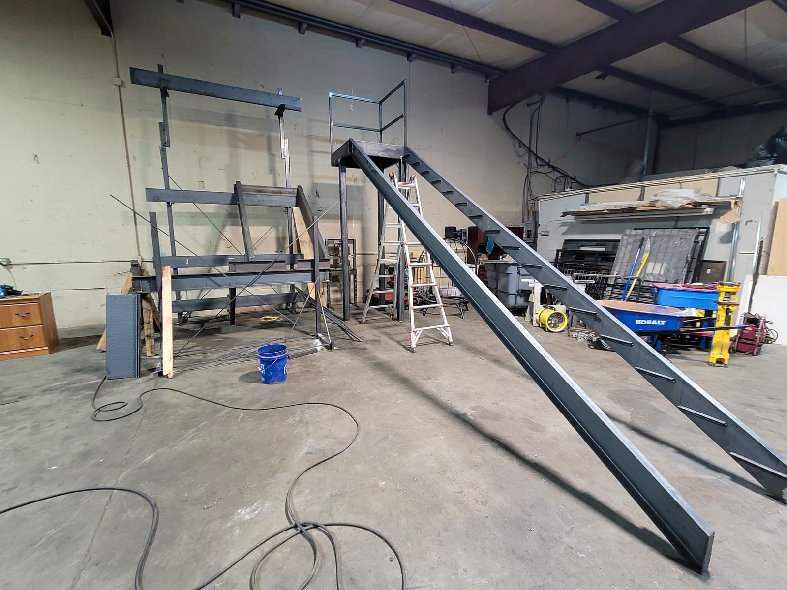 Commercial metal fire escape staircase and railing fabrication for a managed building.