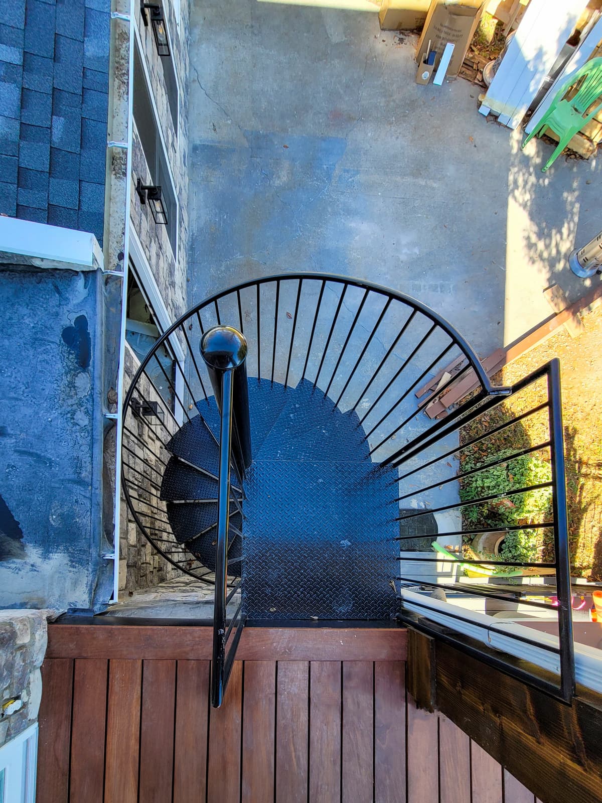 Metal spiral staircase with curved stair assembly.