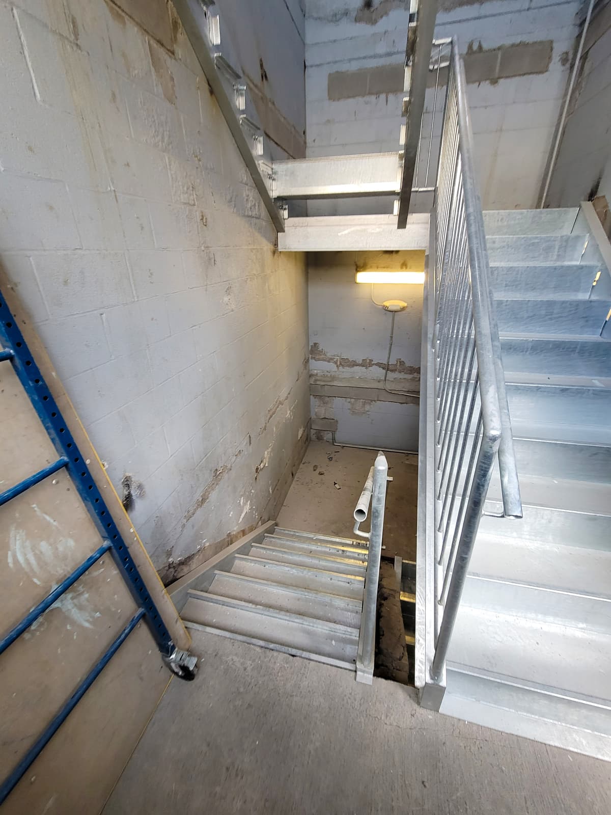 Commercial metal staircase rebuild with welded tread support.